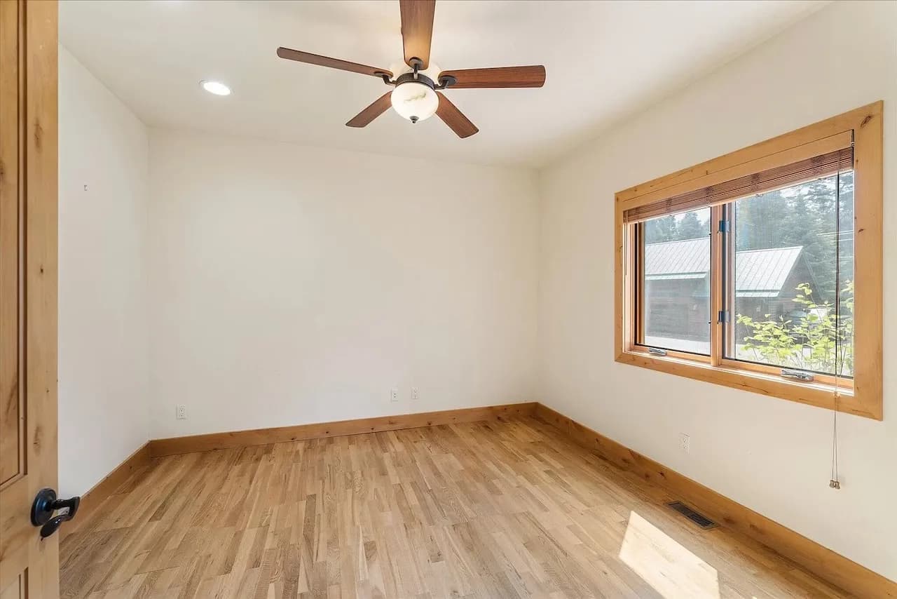 Guest bedroom with wooded views