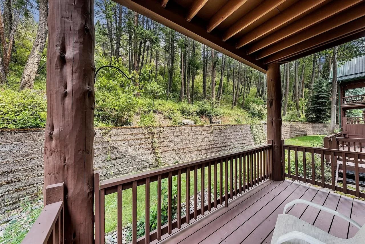 Covered deck overlooking wooded greenery