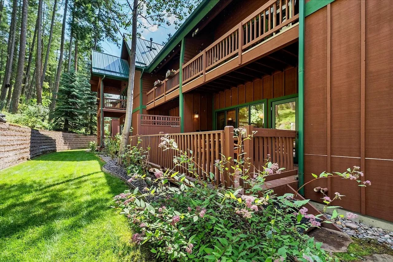 Wraparound covered decks framed by evergreens