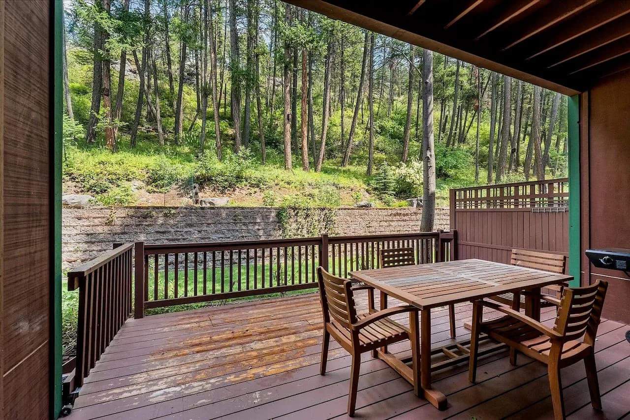 Covered deck dining surrounded by pines