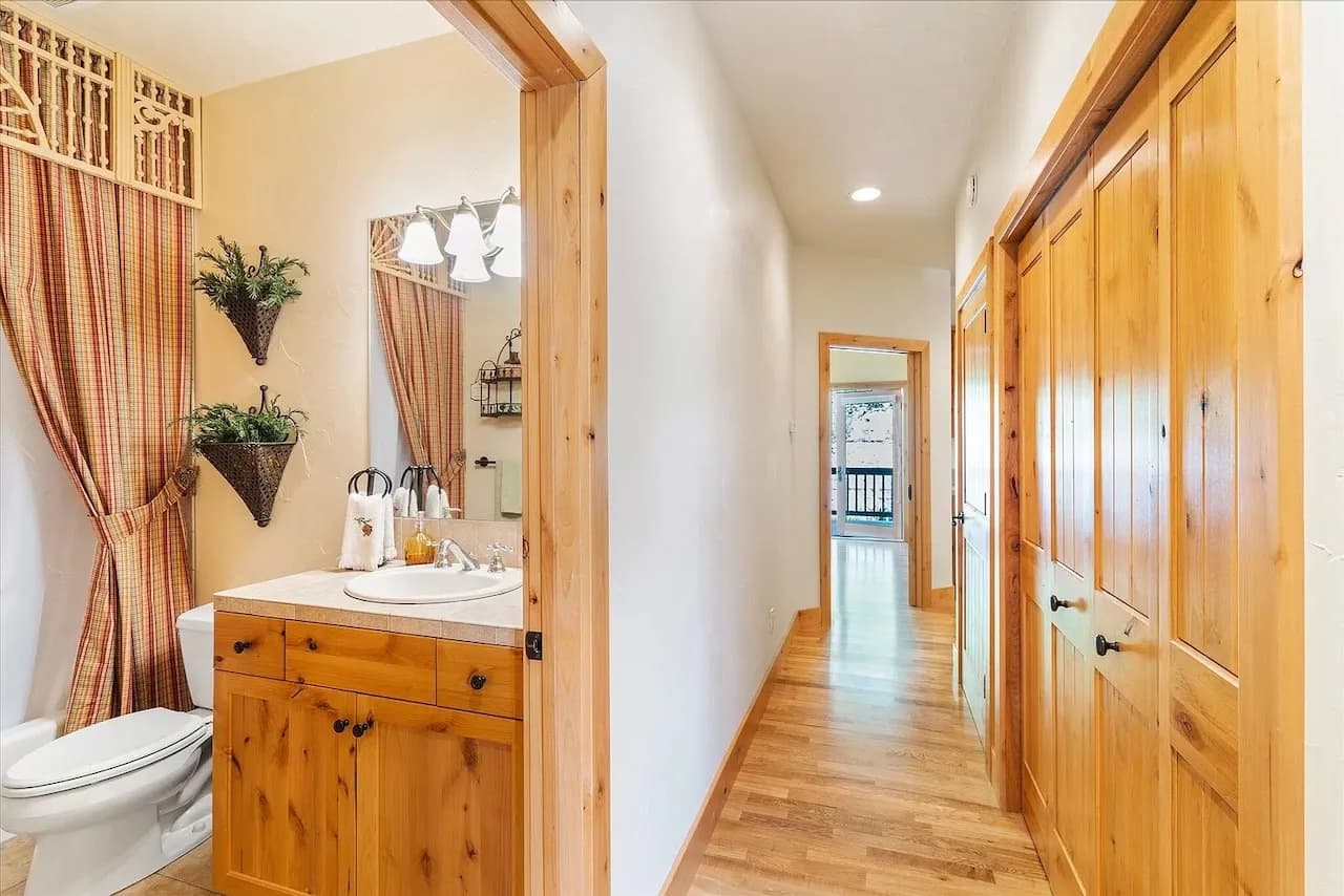 Guest bath and hallway with pine storage