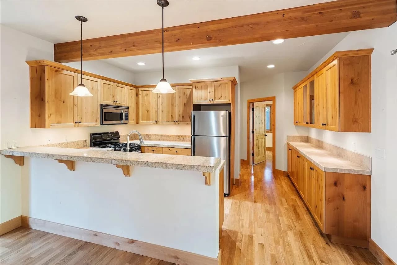 Kitchen with exposed beam and breakfast bar
