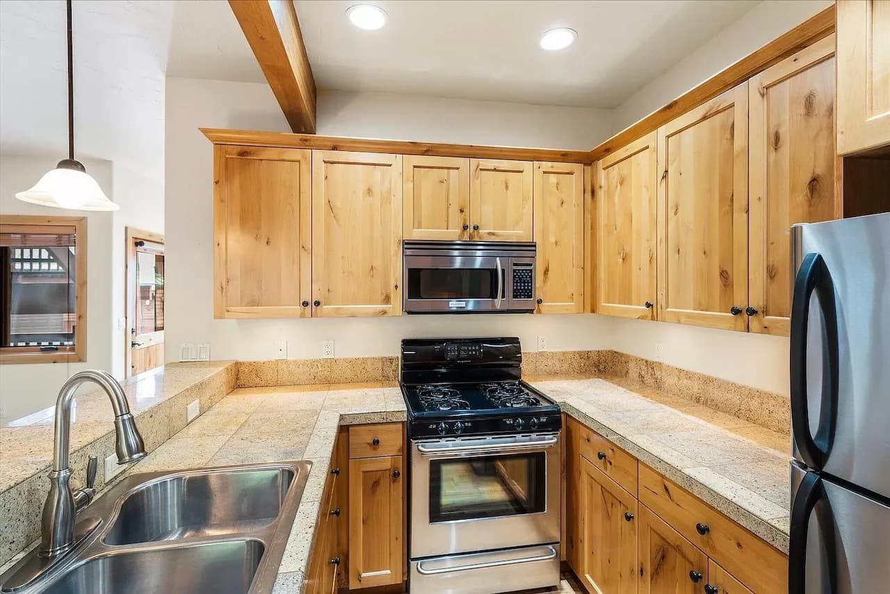 Knotty pine kitchen with stainless gas range