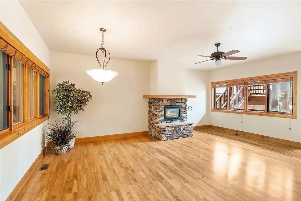Open living room with stacked-stone gas fireplace