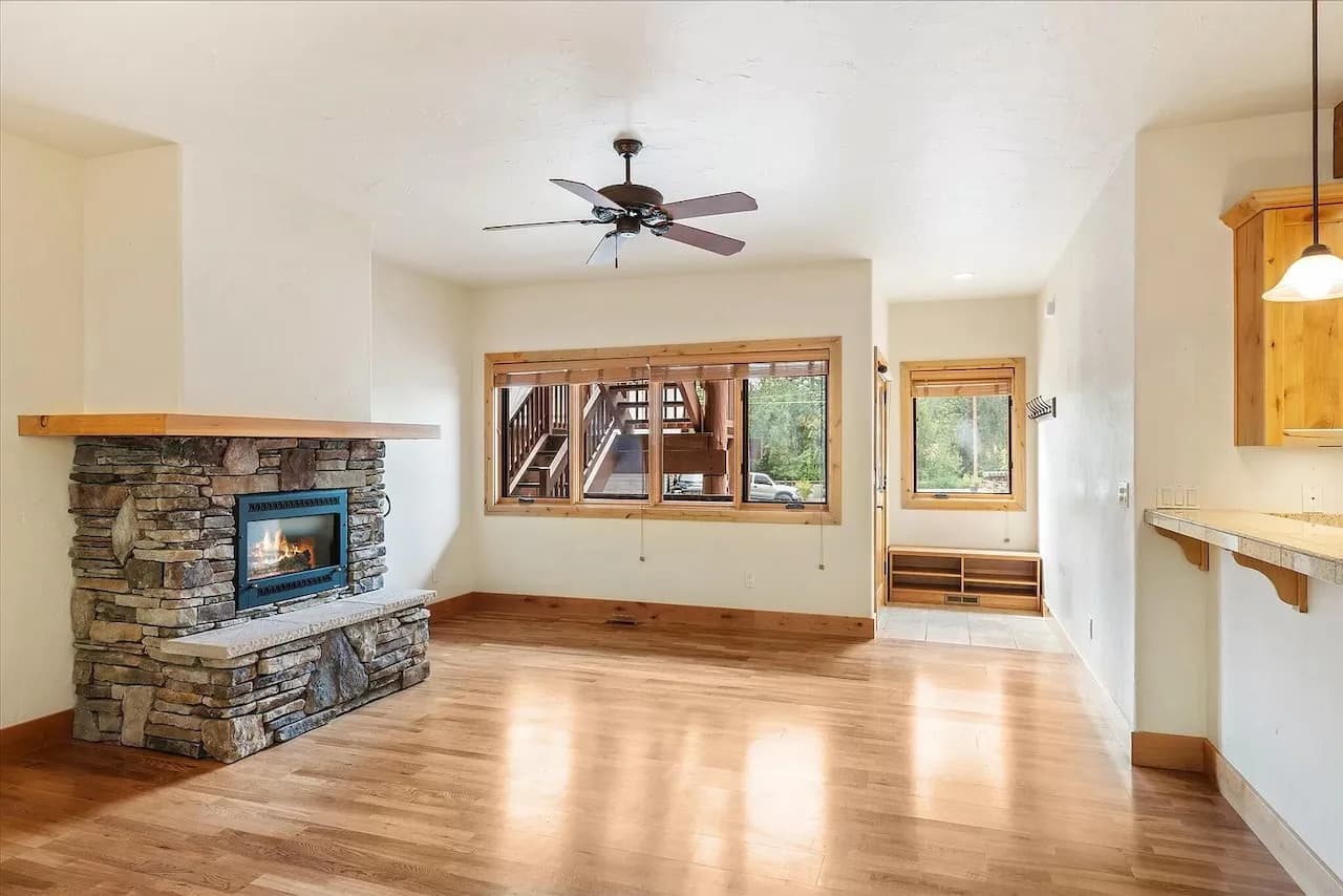 Living room with floor-to-ceiling stone fireplace